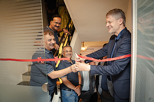 Siegfried Wanker joyfully cuts the red ribbon
