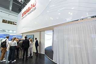 A well-attended panel discussion directly at the booth, showcasing the high level of interest and active audience engagement from trade fair visitors.