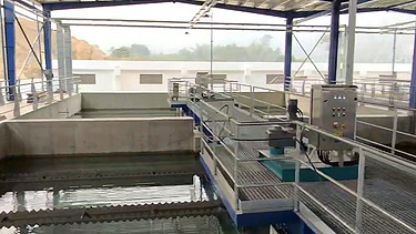 Water filtration basins at the Xuan-Mai Surface Water Treatment Plant, featuring filtration units, walkways, monitoring equipment, and treated water channels.
