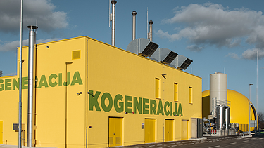 A bright yellow industrial building with the word 