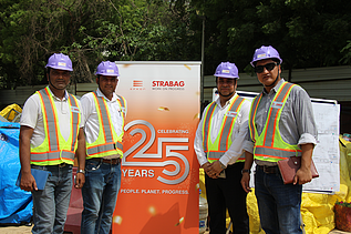 people in front of 25 years banner 