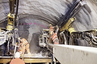 The image shows a tunnel construction site where safety measures and systems are particularly important.