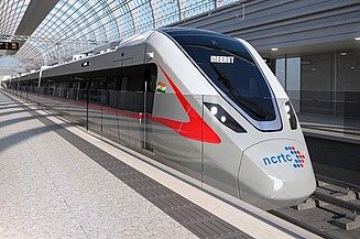 A modern, aerodynamic rapid transit train at a station with a vaulted glass roof. This represents advanced infrastructure for efficient, sustainable regional mobility and passenger transport.